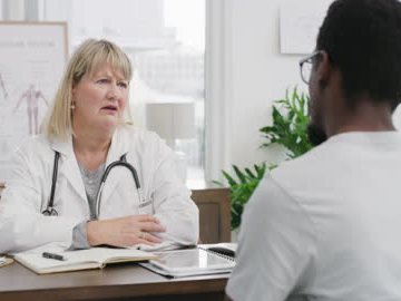 Doctor having a warm consultation with a patient in a clinic office